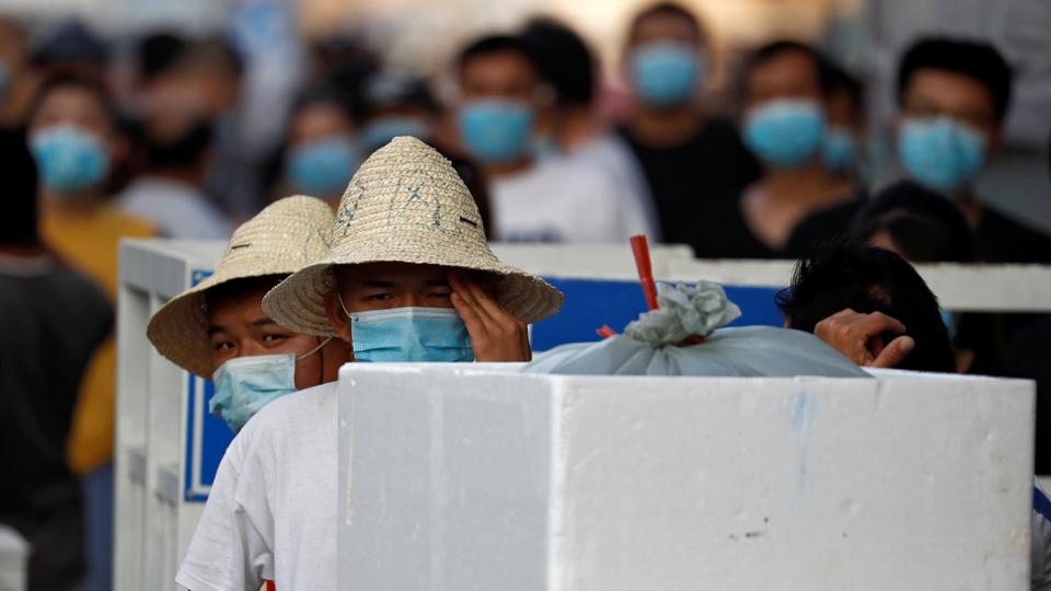 People are wearing face masks inside the Jingshen seafood market, closed for business after new coronavirus infections were detected, in Beijing, China, June 12, 2020.