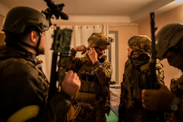 New York Times photo of Bratstvo members preparing for a mission