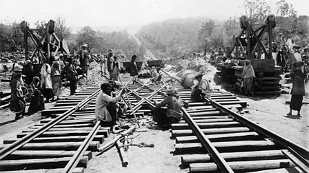 A black and white photograph of indentured labourers working on the Uganda Railway.